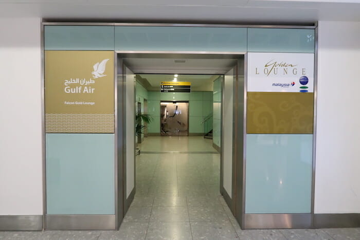 an elevator with signs in the middle of the hallway