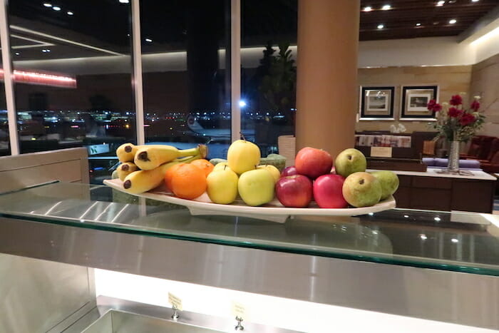 a plate of fruit on a glass shelf