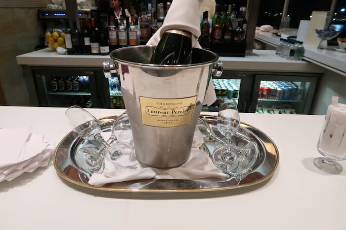 a champagne bottle in a bucket on a tray