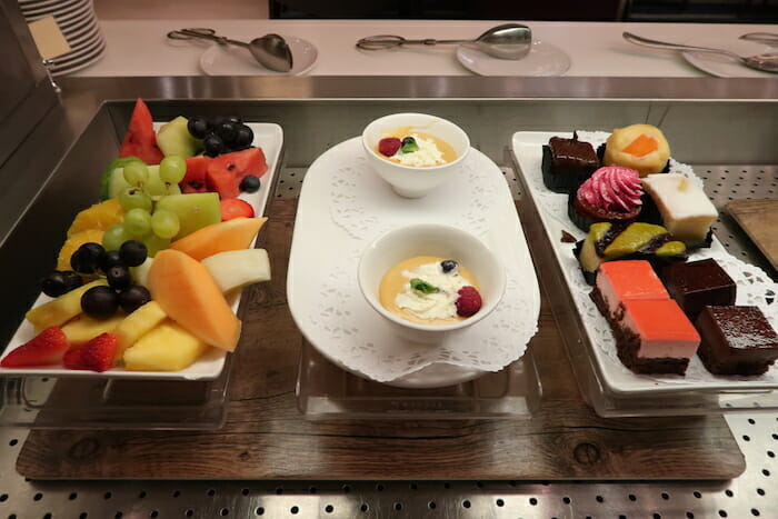 a tray of fruit and desserts