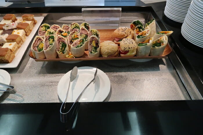 a tray of sandwiches and a plate of food