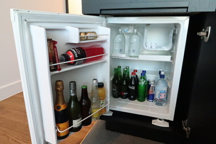 a mini fridge with bottles of alcohol