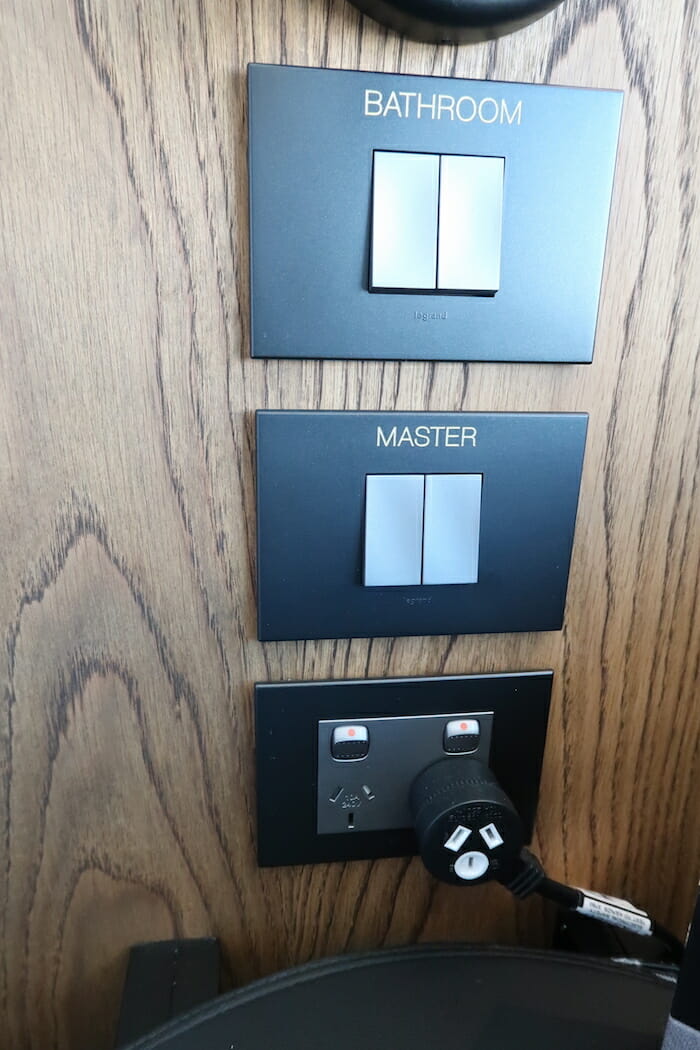 a wall with switches and plugs