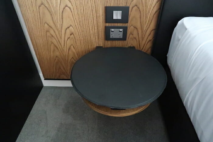 a round table next to a wood paneled wall