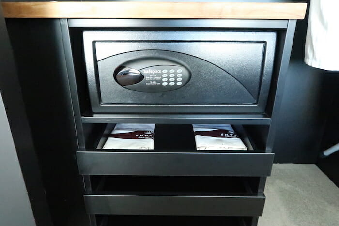 a black safe with a combination lock and a shelf