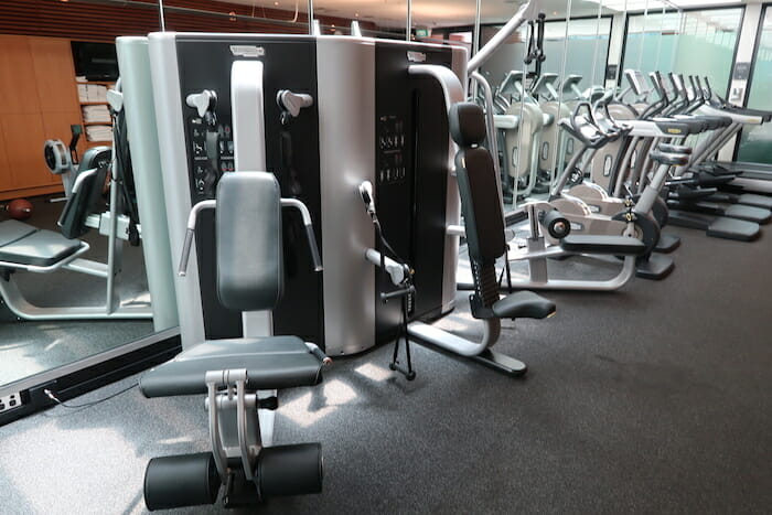 a group of exercise machines in a gym