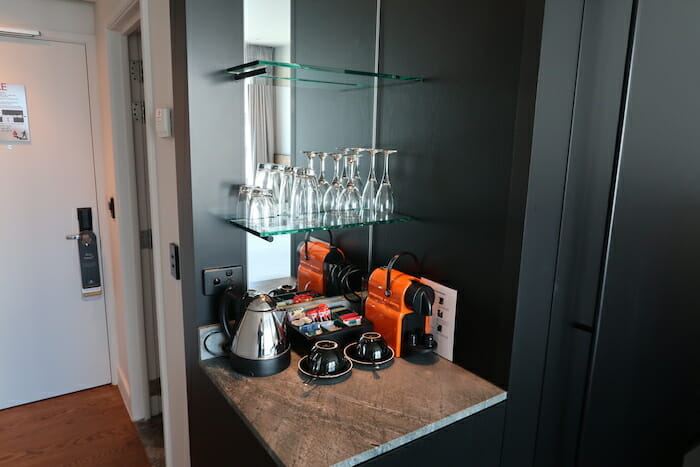 a shelf with glasses and coffee cups on it