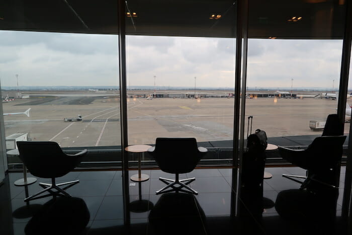 a room with chairs and a table and luggage