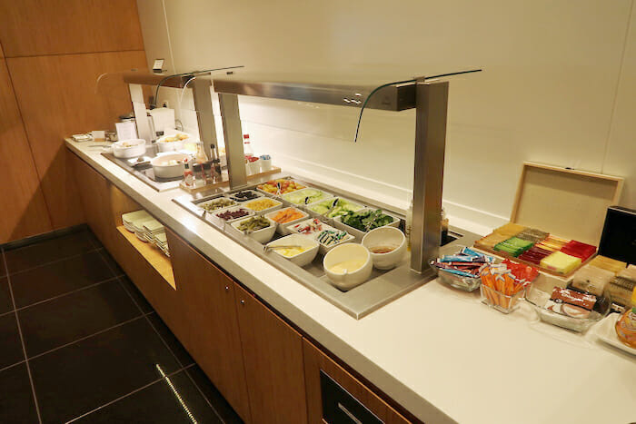 a buffet line with food in bowls