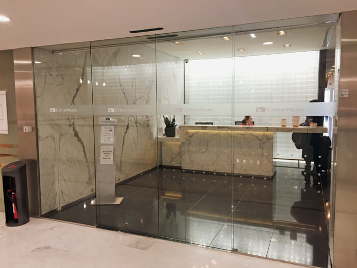 a glass wall with a counter and a person sitting in front of it