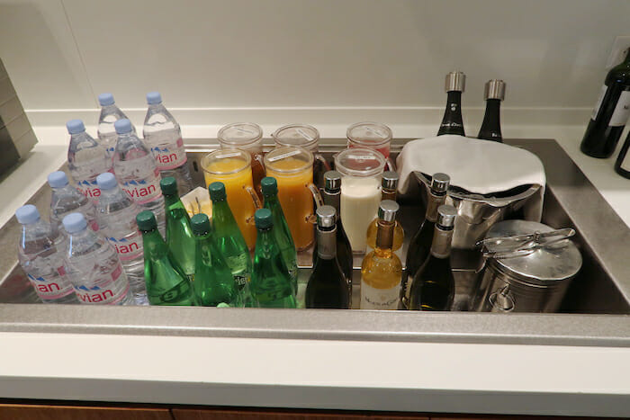 a sink full of bottles and liquid