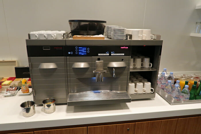 a machine with cups and cups on a counter