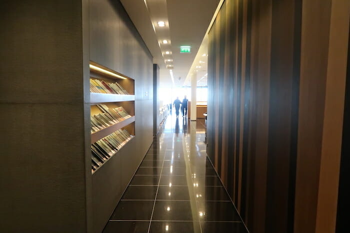 a hallway with shelves of books