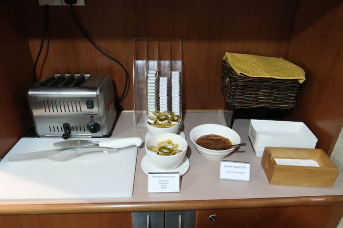 a counter with bowls of food and a knife