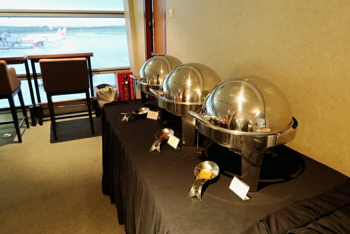 a group of silver food containers on a table