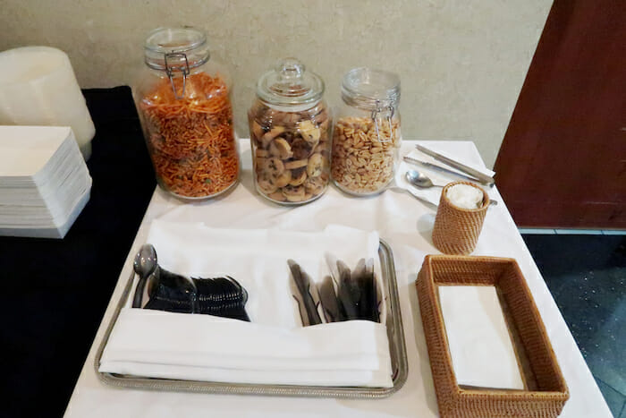 a table with food in jars and spoons