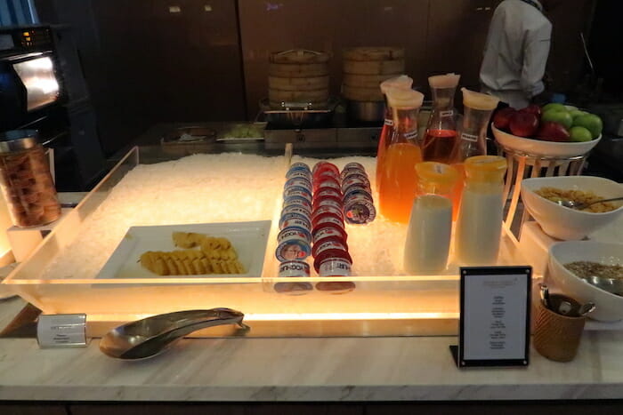 a glass display with different drinks on it