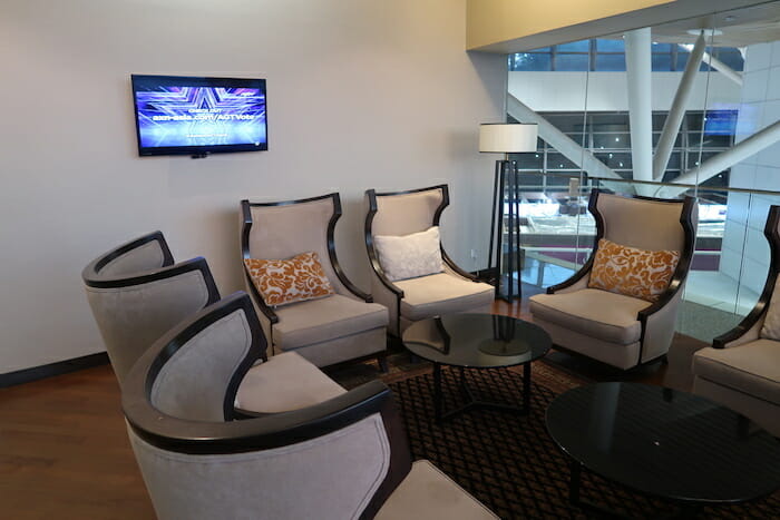 a room with chairs and a television on the wall