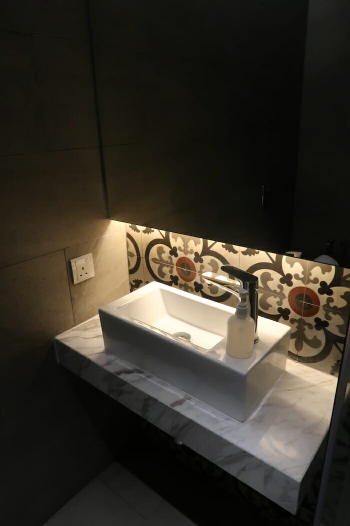 a sink with a soap dispenser on a counter