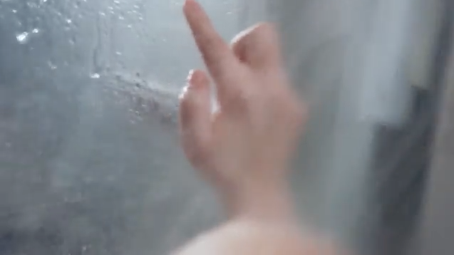 a hand reaching out to the side of a glass wall