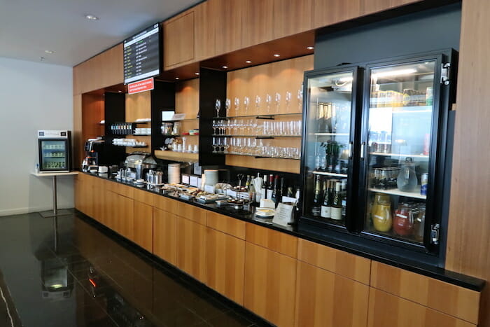 a counter with drinks and glasses on it