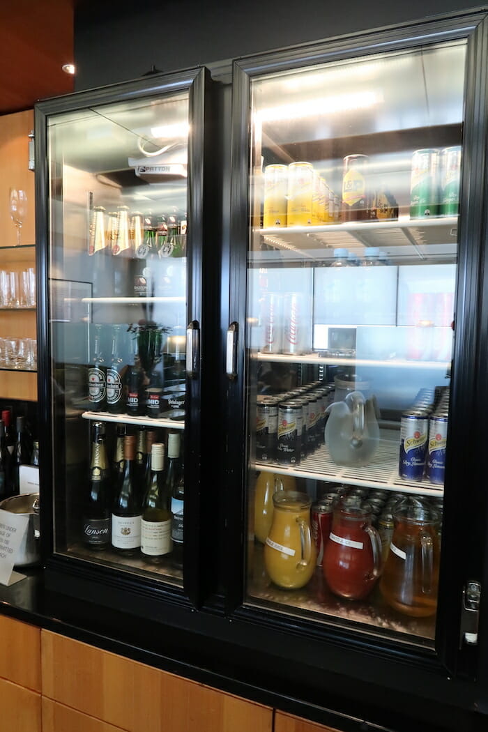 a glass case with bottles and cans in it