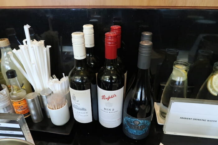 a group of bottles of wine and straws