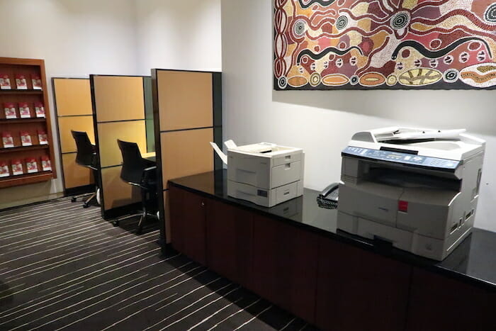 a room with a printer and office cubicles