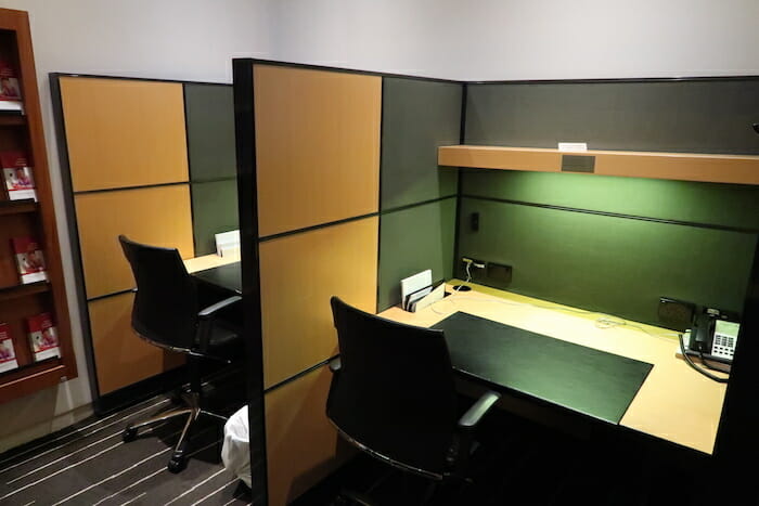 a desk and chairs in a cubicle