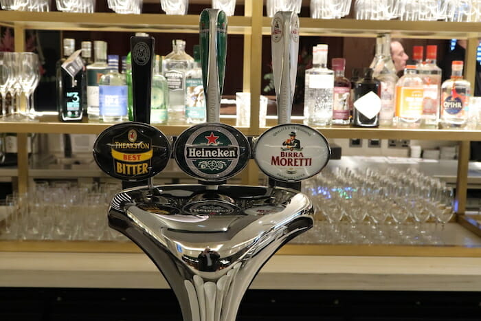 a beer tap with several different labels on it