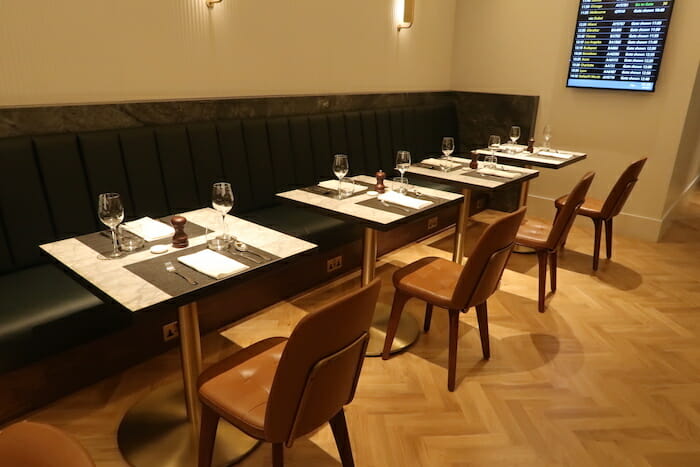 a table with empty wine glasses and chairs