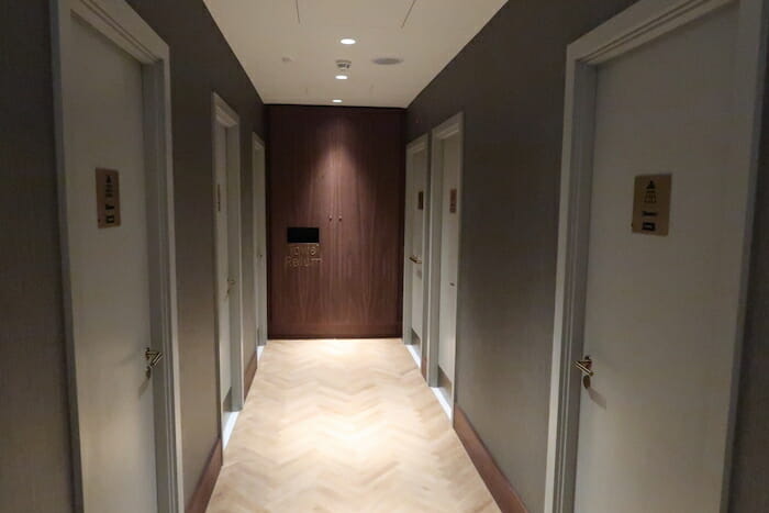 a hallway with doors and a light on the floor