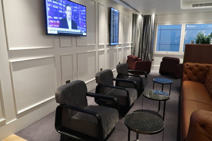 a room with chairs and a television on the wall