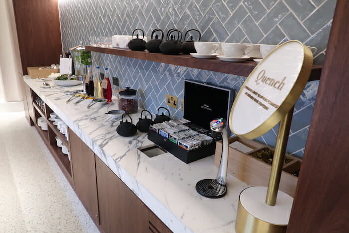 a counter with a variety of teas and teapots on it