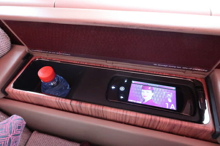 a bottle and a device in a shelf