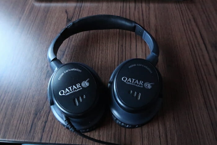 a pair of black headphones on a wood surface