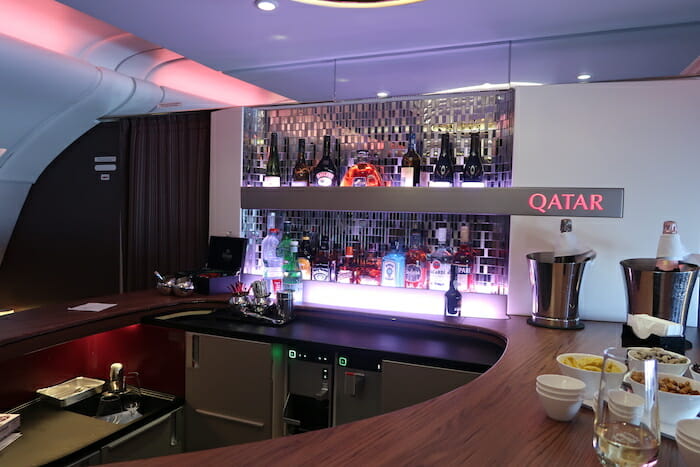 a bar with a counter and bottles of alcohol