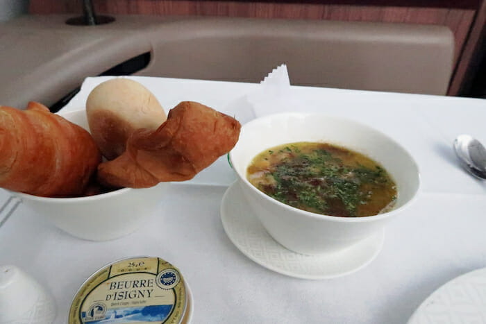 food in a bowl and a bowl of soup on a tray