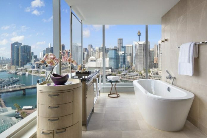 a bathroom with a view of a city and a river