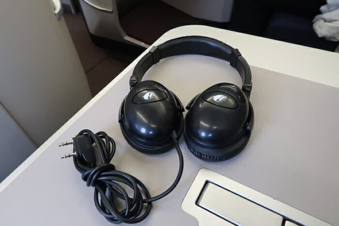 a pair of black headphones on a white surface