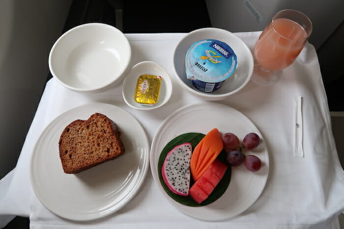 a plate of food and a glass of juice