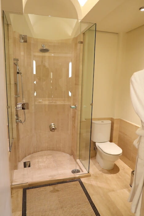 a bathroom with a glass shower and toilet