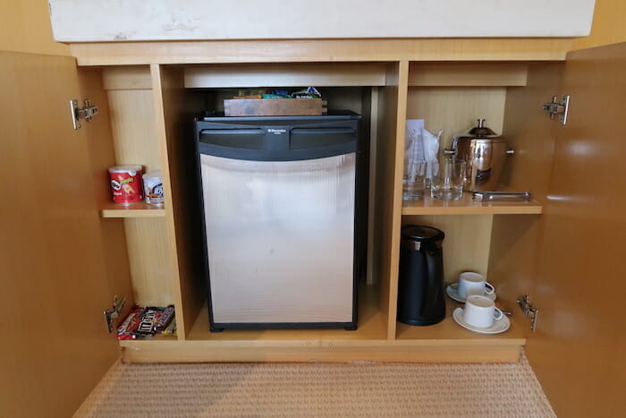 a small refrigerator in a cabinet