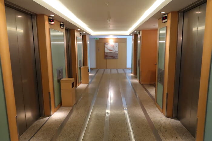 a hallway with elevators and lights