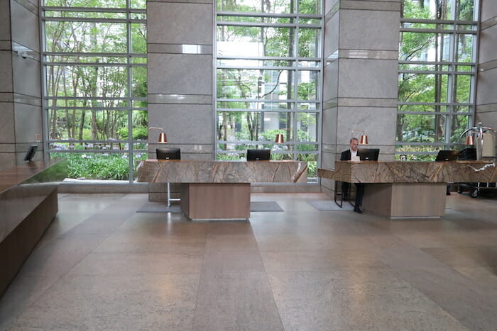 a man sitting at a desk in a lobby