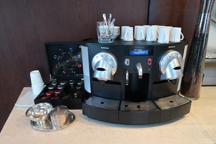 a machine with cups and utensils on a table