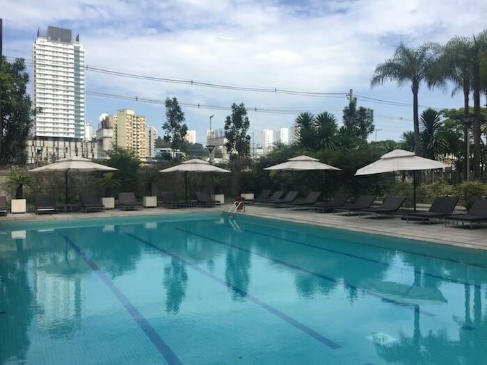 a pool with umbrellas and chairs