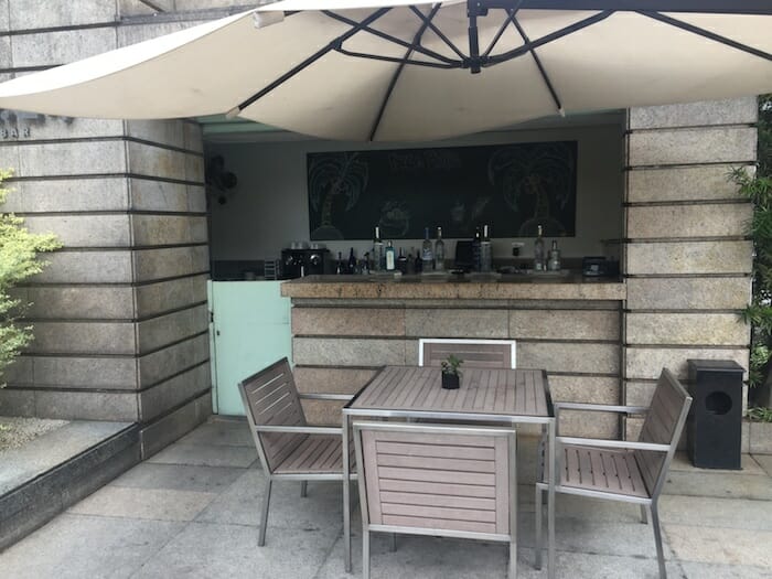 a table and chairs under an umbrella