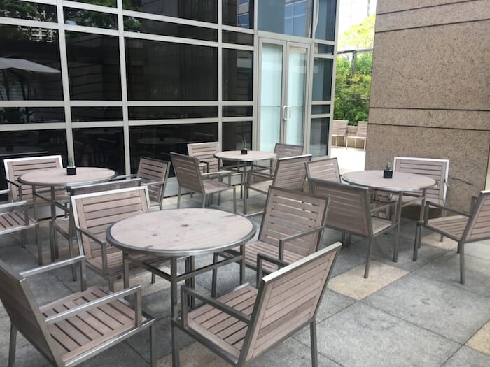 a group of tables and chairs outside a building