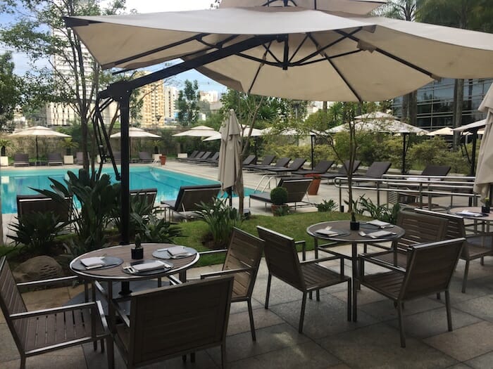 a patio with chairs and umbrellas